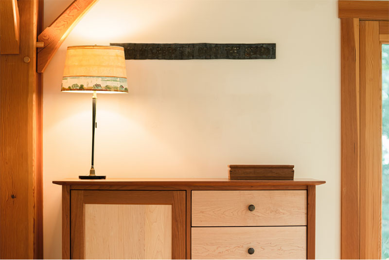 mixed wood dresser with lamp