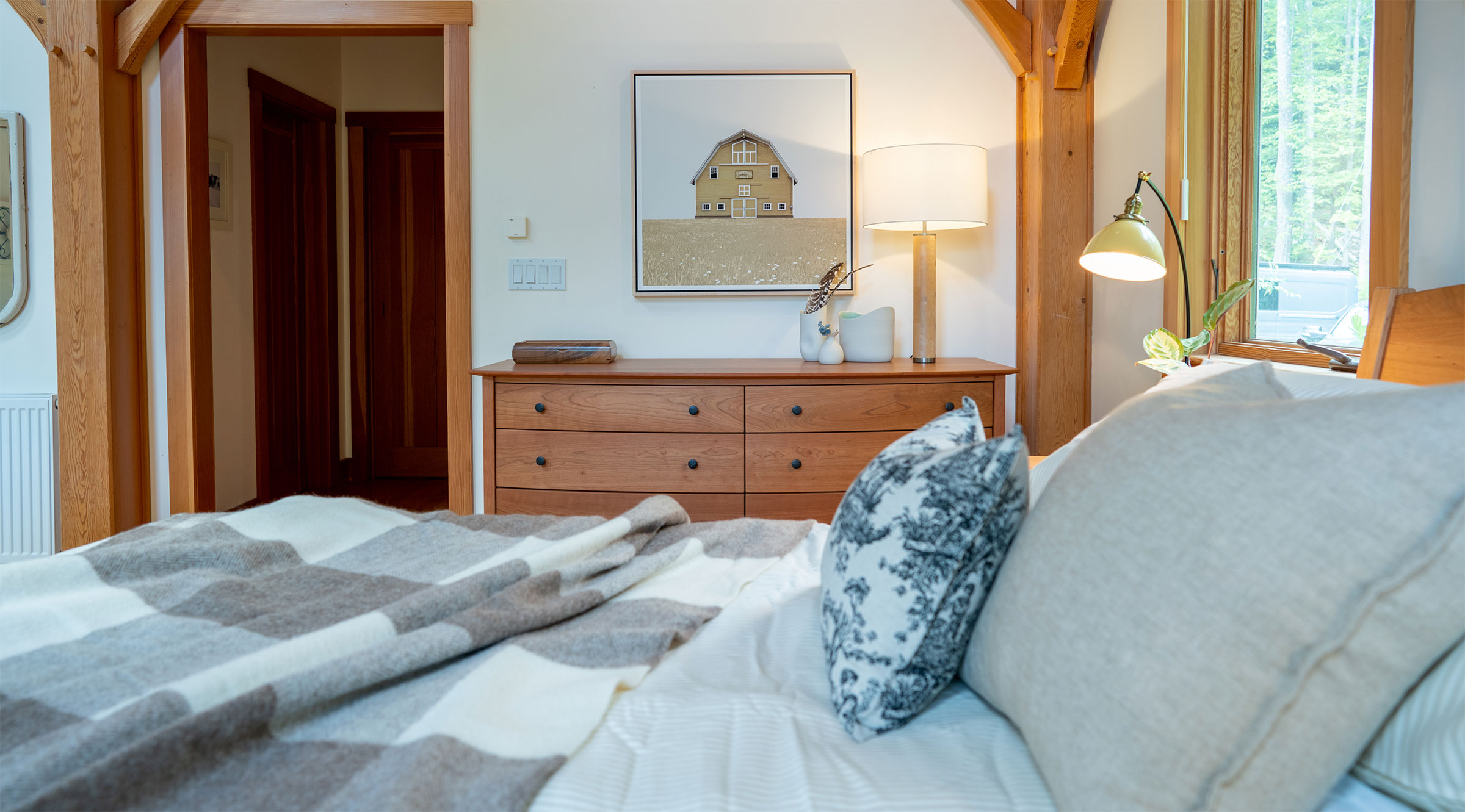 bed in bedroom in post and beam house