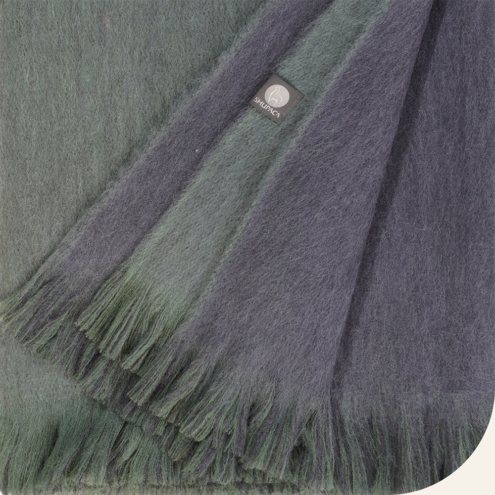 close up of green and navy blue alpaca throw