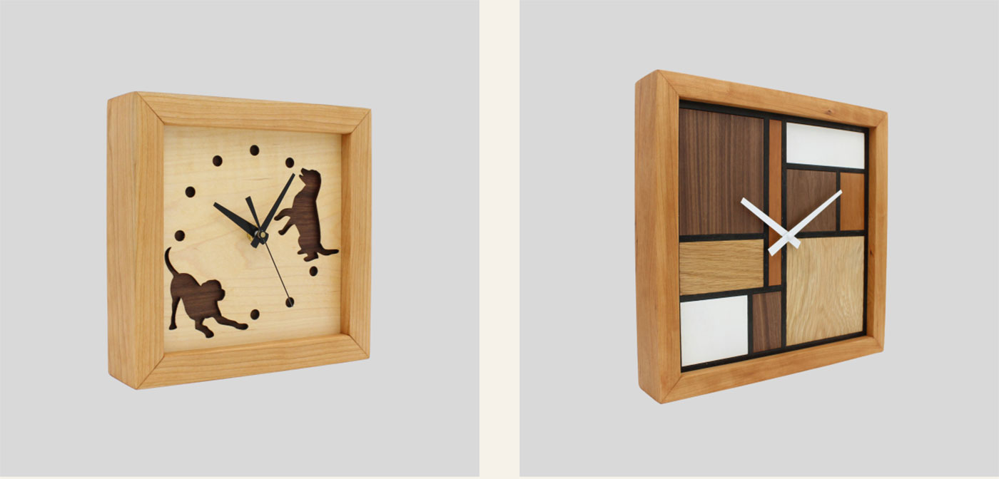 2 wood clocks, one with modern wood design and the other with dogs playing